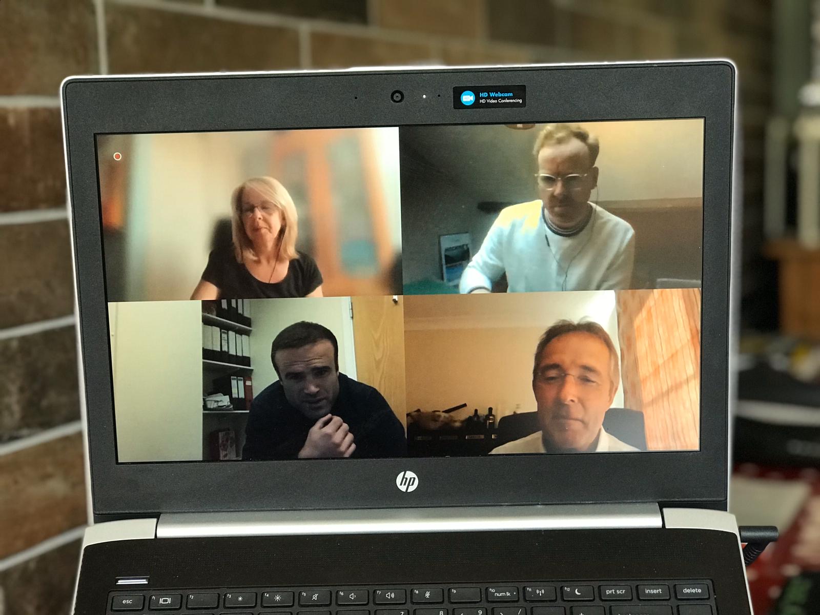Picture of 4 people in an online meeting 