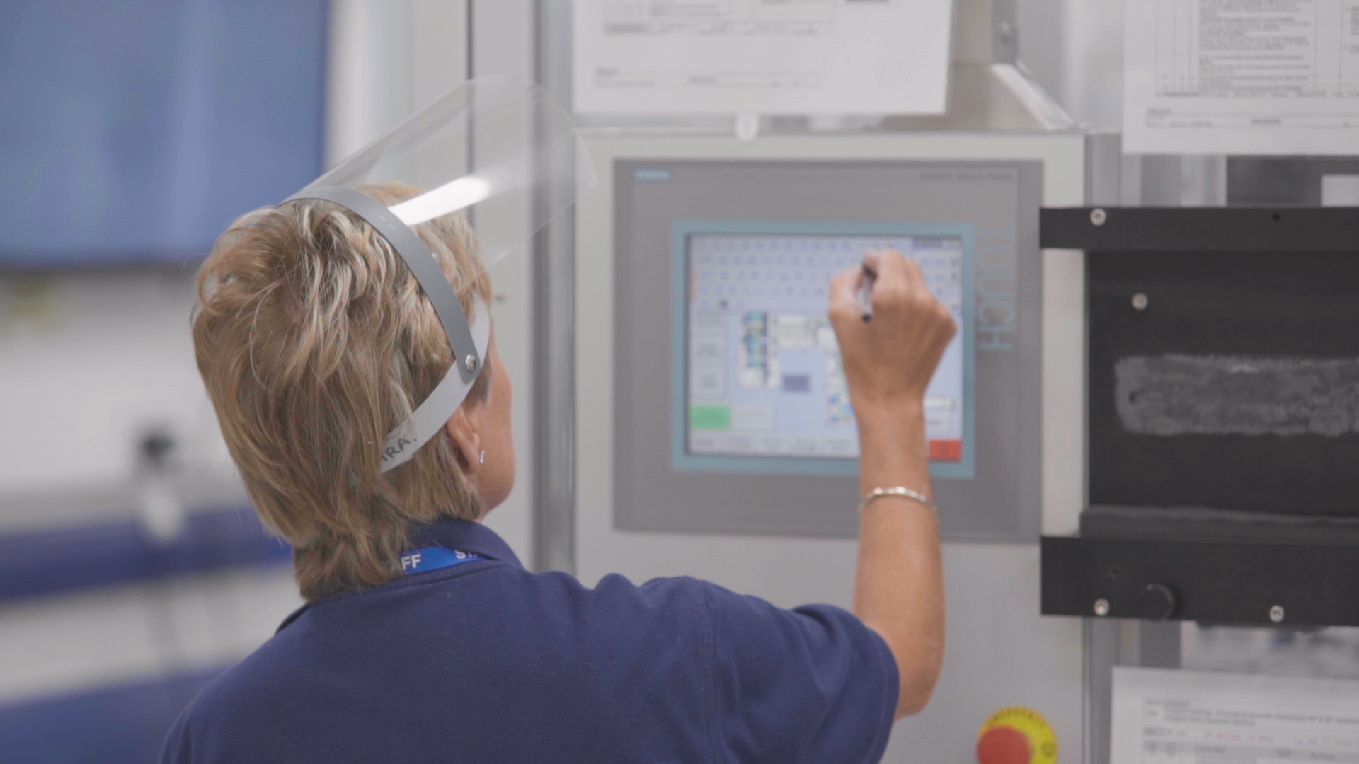 Woman in PPE working on screen