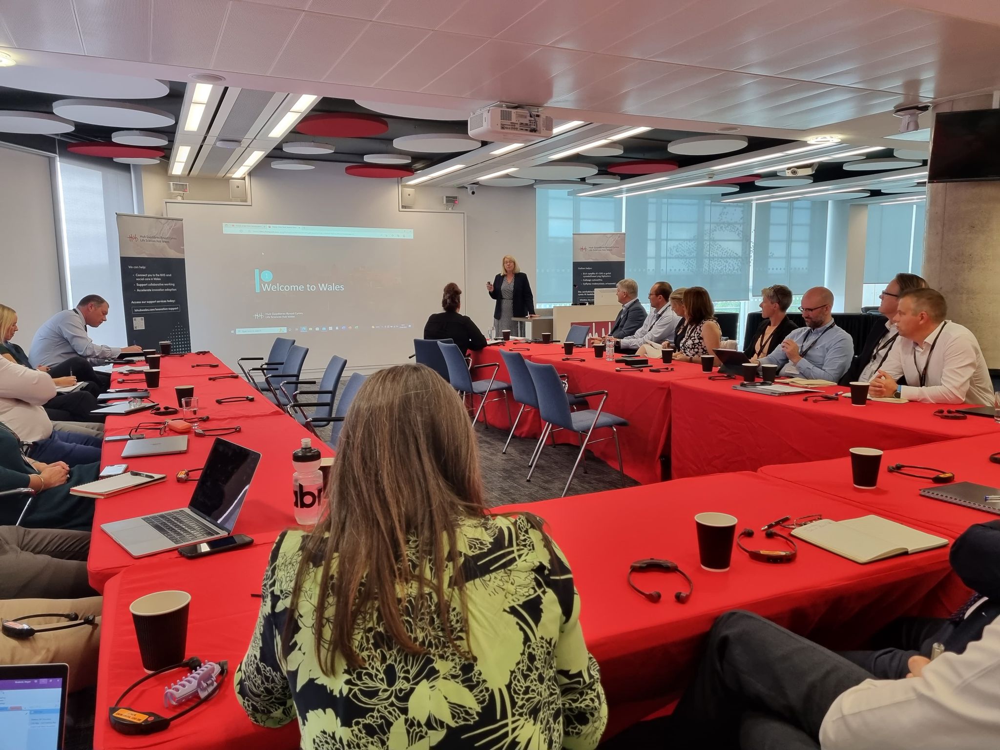 Colleagues sitting around a table watching a presentation