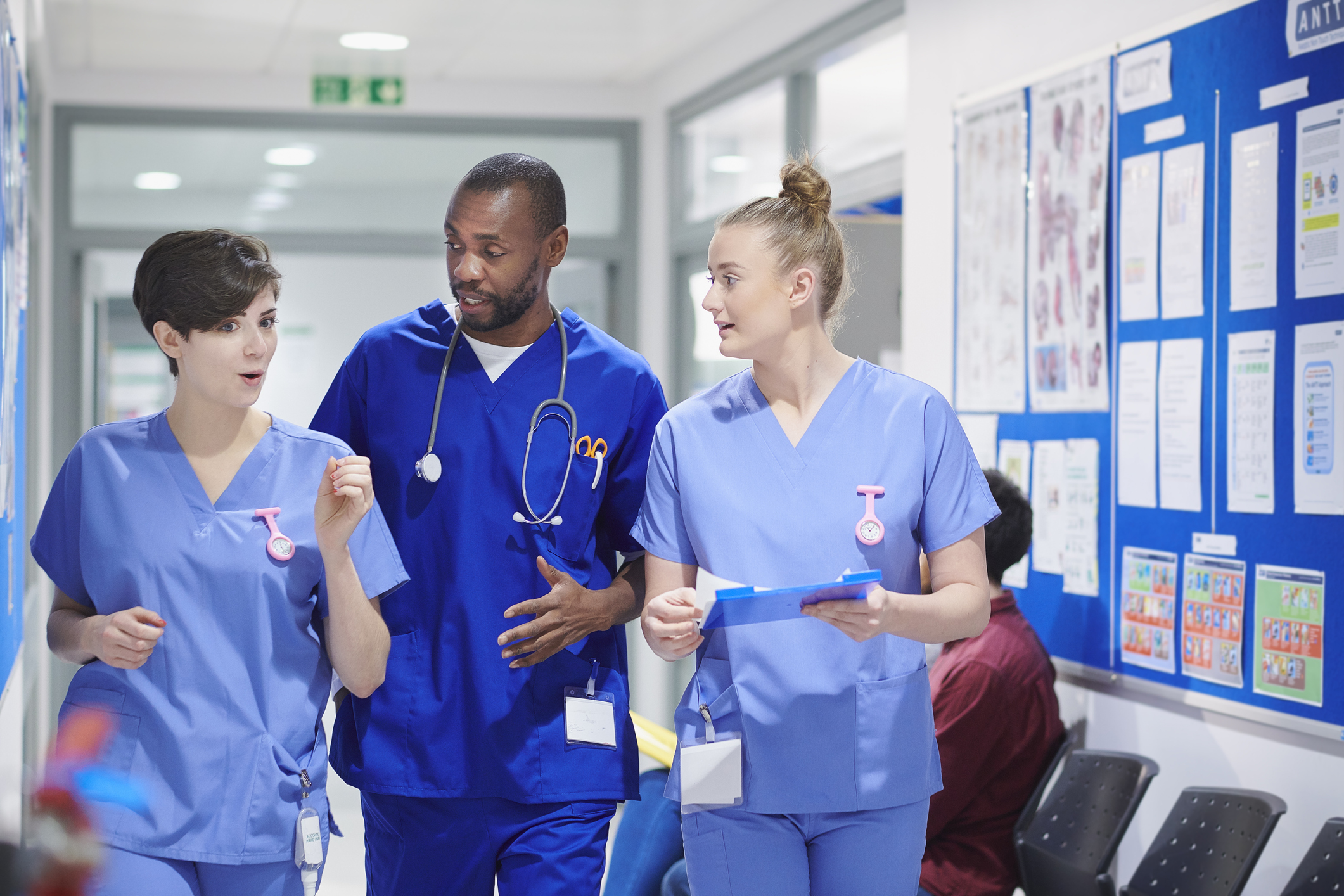 Medical team walking down a hospital corridor.