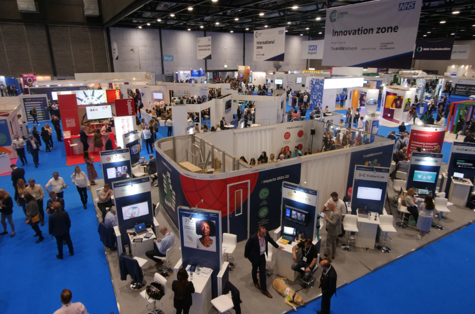 A variety of exhibition stands in a large auditorium.