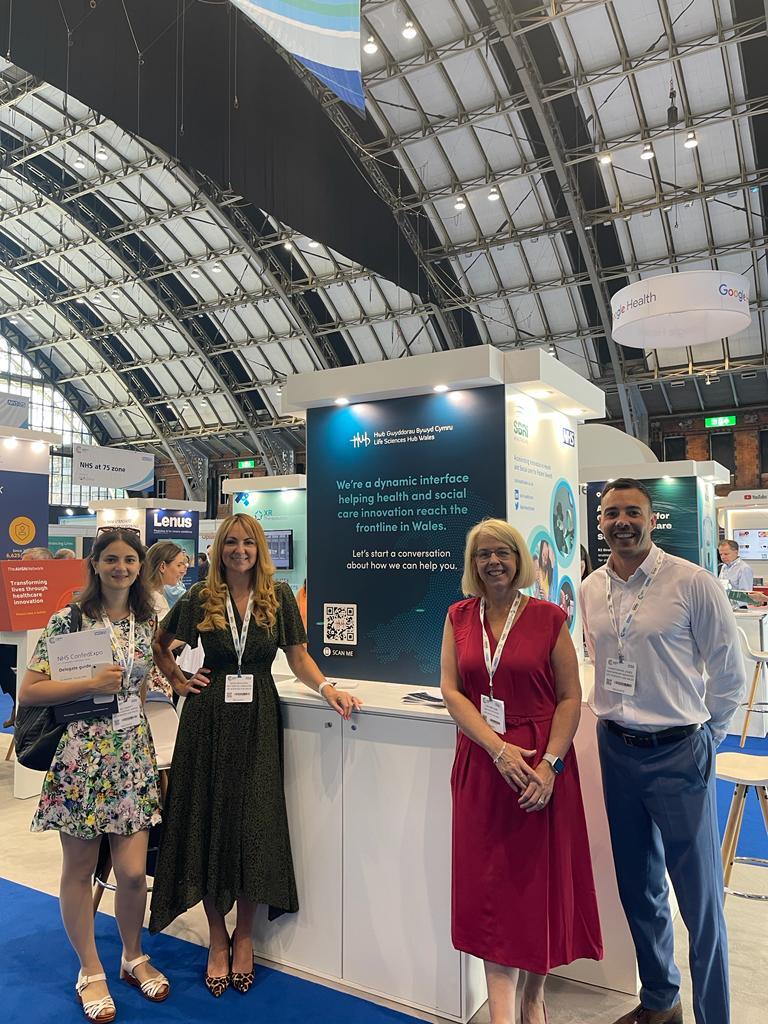 Life Sciences Hub Wales staff stood next to their stand at NHS Confed