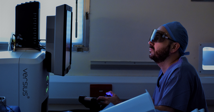 James sits at the robotic control panel