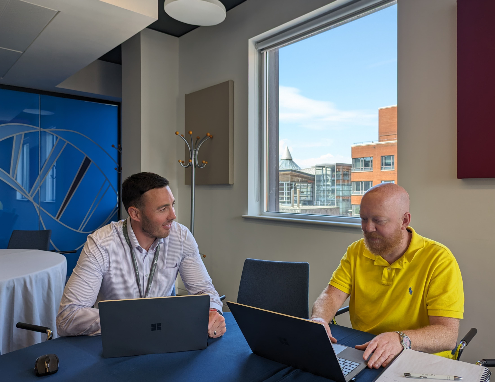 Two Life Sciences Hub Wales colleagues sitting at a table