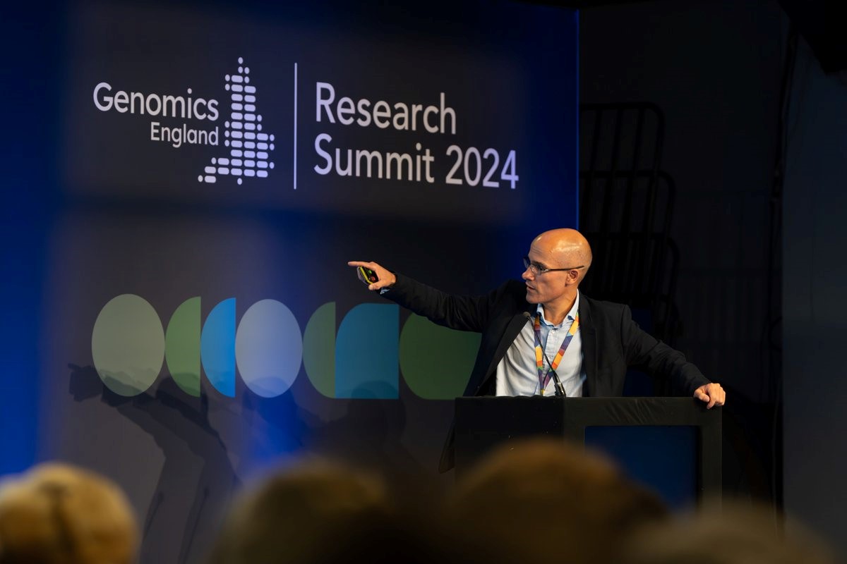 Man pointing at screen whilst presenting at GEL Research Summit 2024.