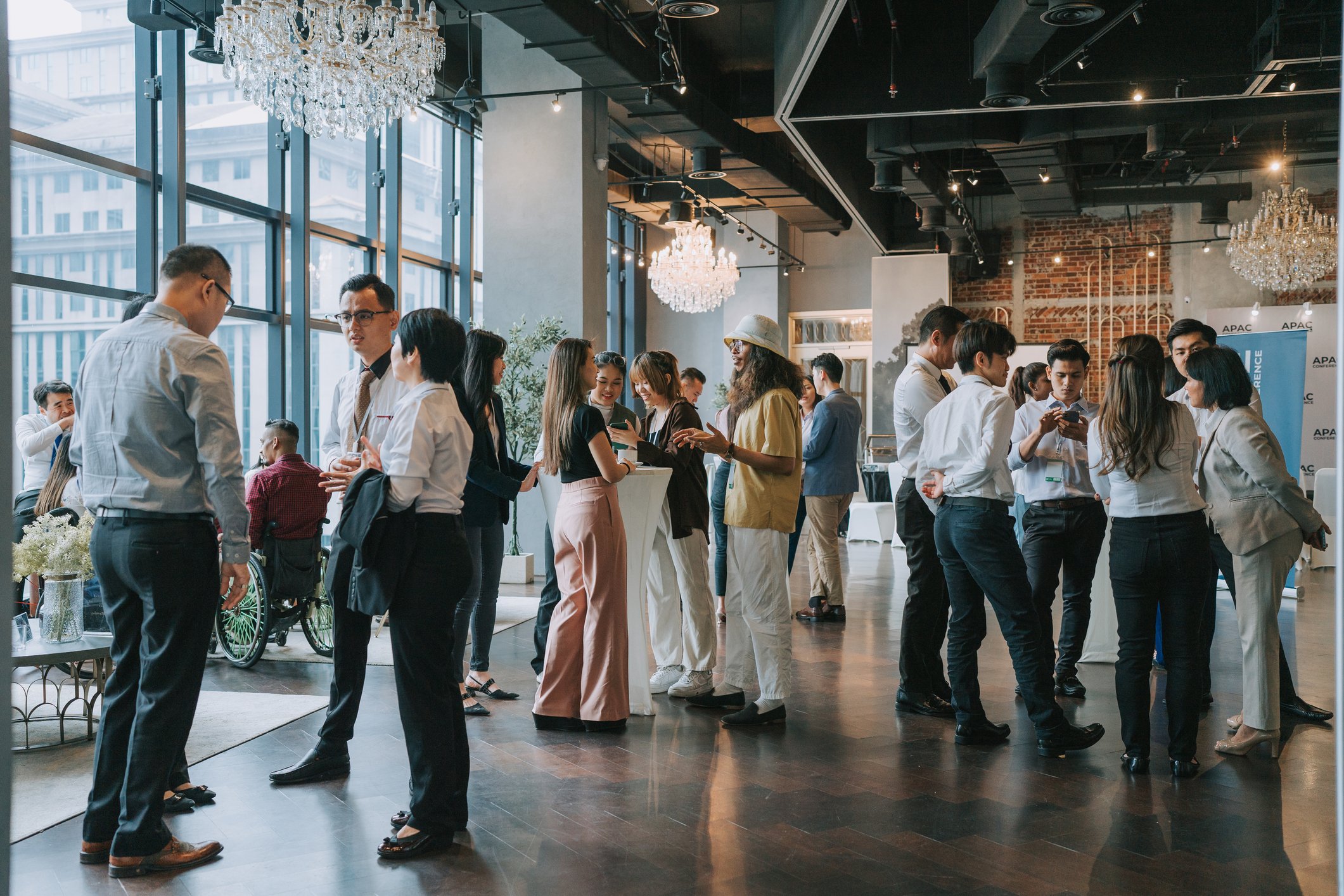 A large group of people at a conference, mingling and networking