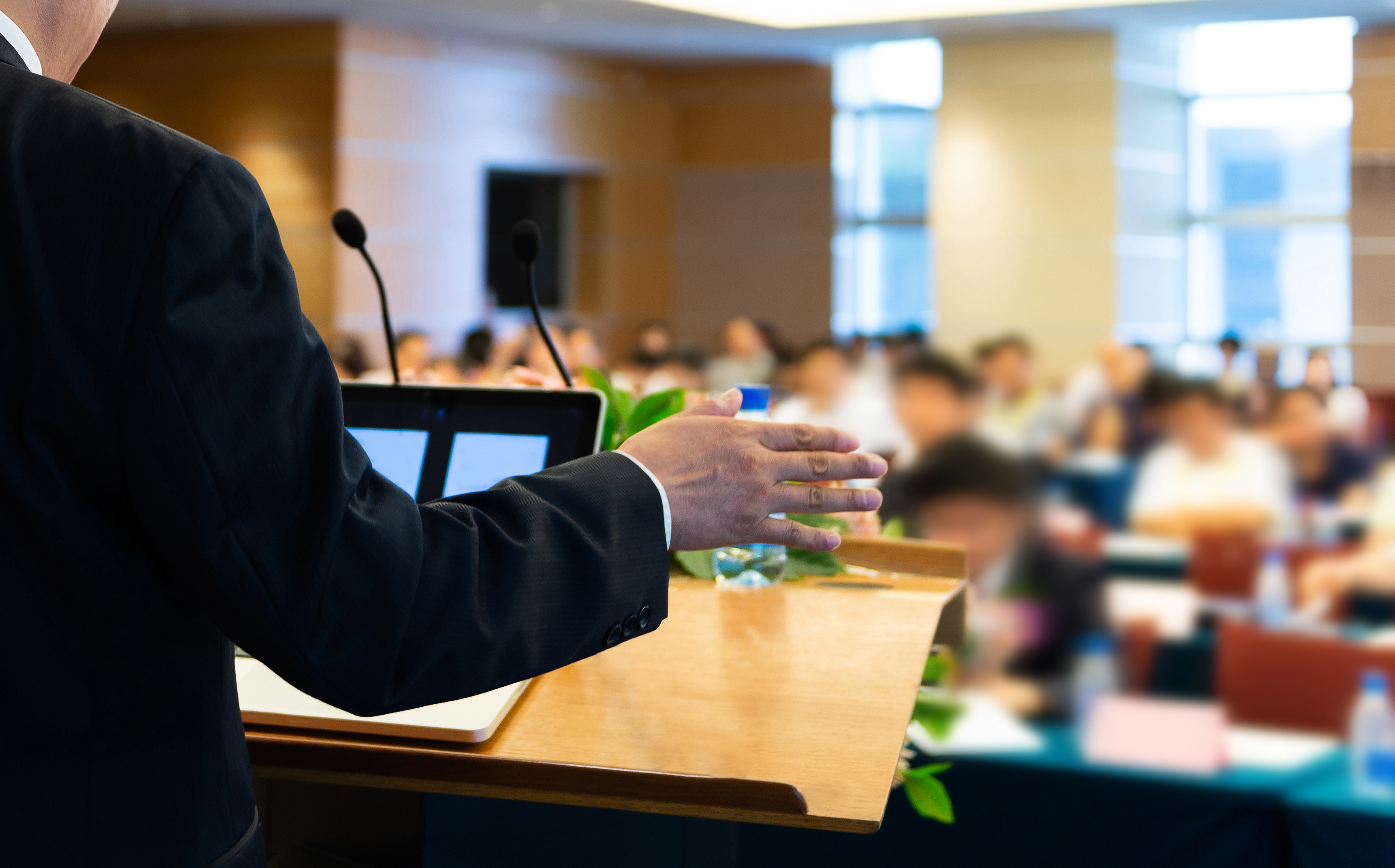 A man speaking at a lecture