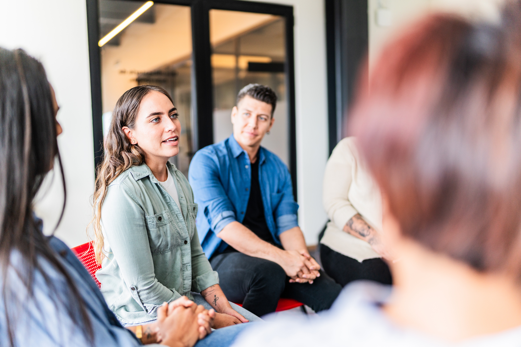 A person talking and a group of people listening to her