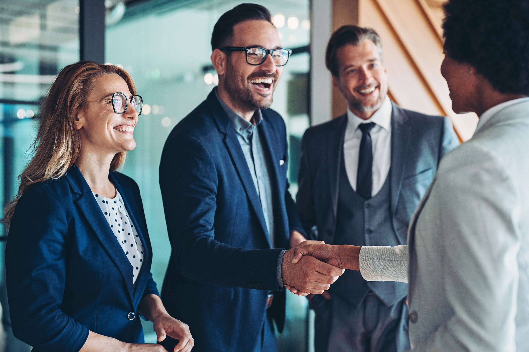 A group of people greeting and shaking hands