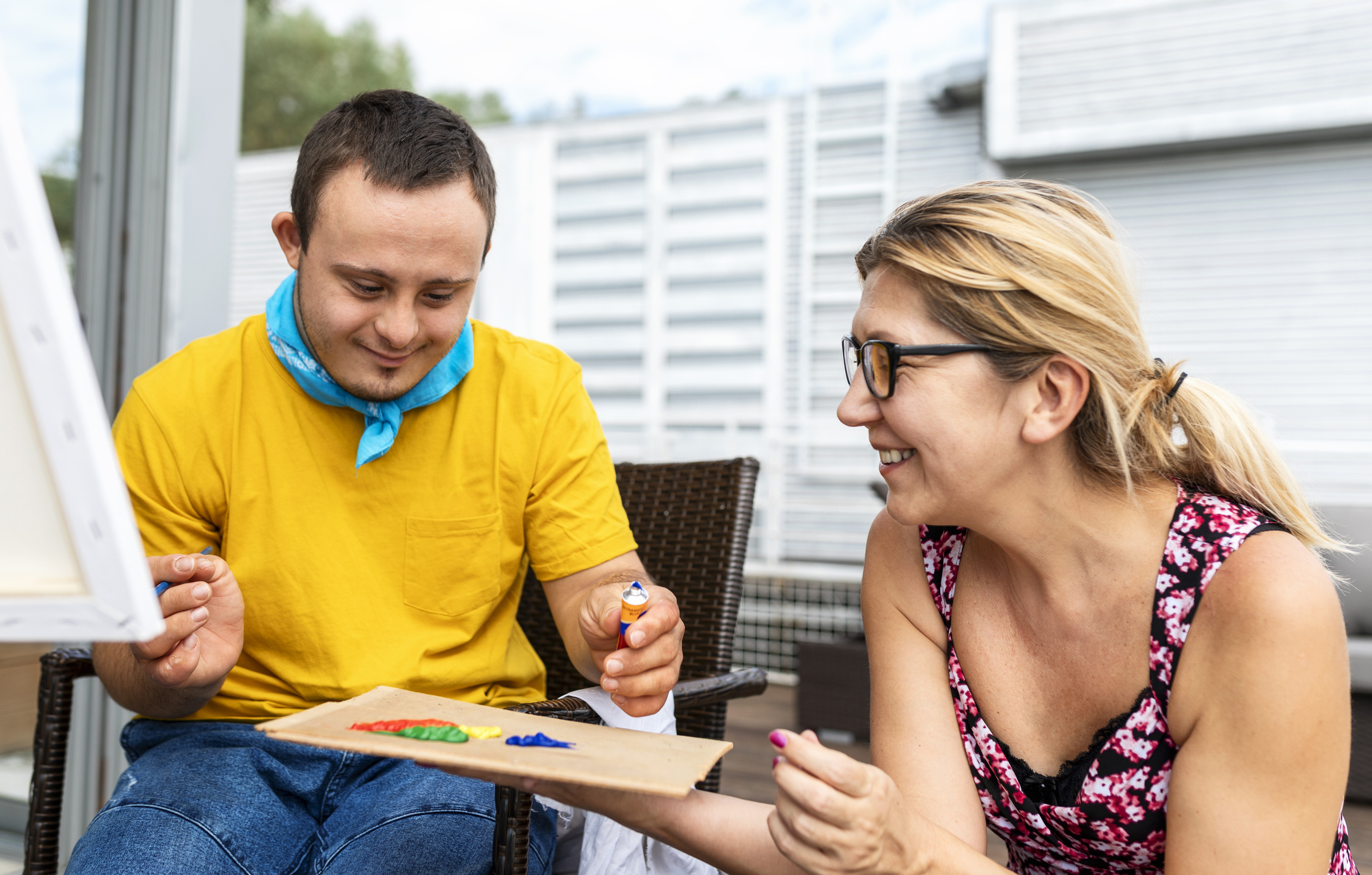 A social worker painting with their service user