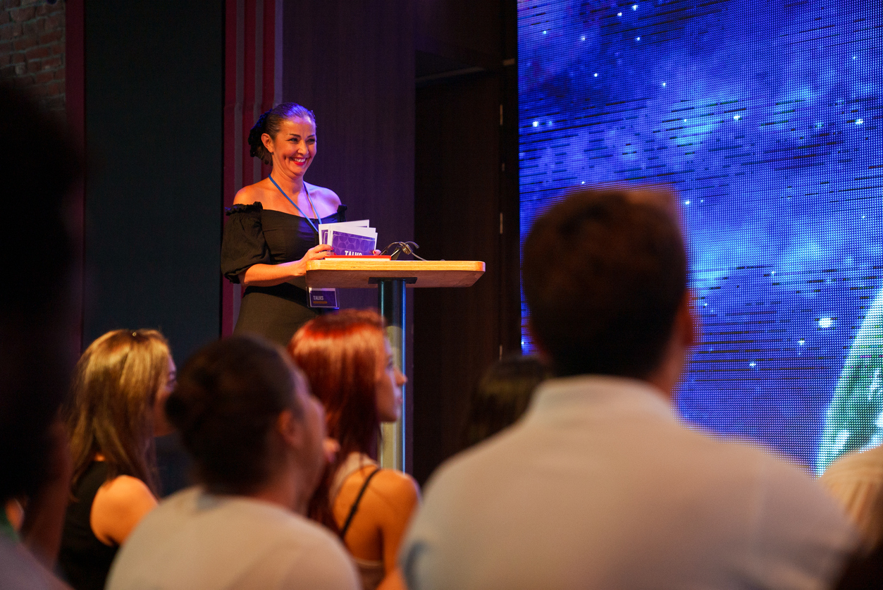 A woman presenting an award at a ceremony