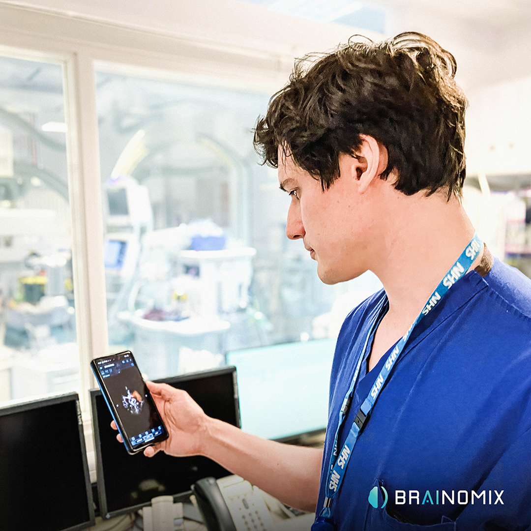 An NHS worker looking at a brain scan on a phone