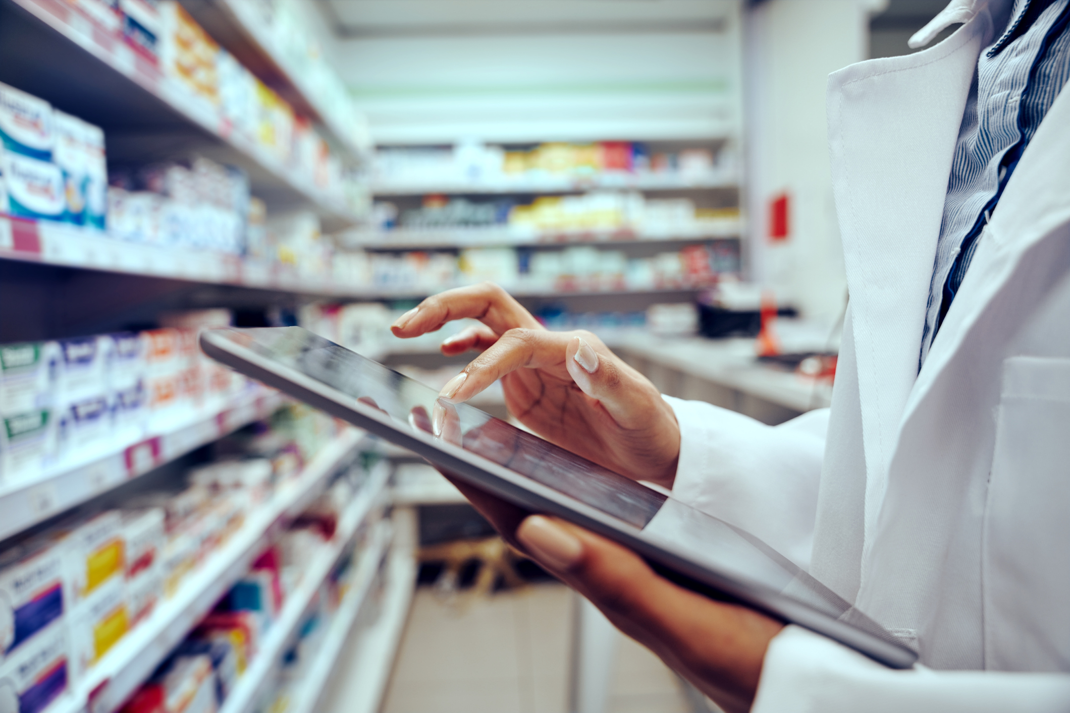 A pharmacist holding an iPad