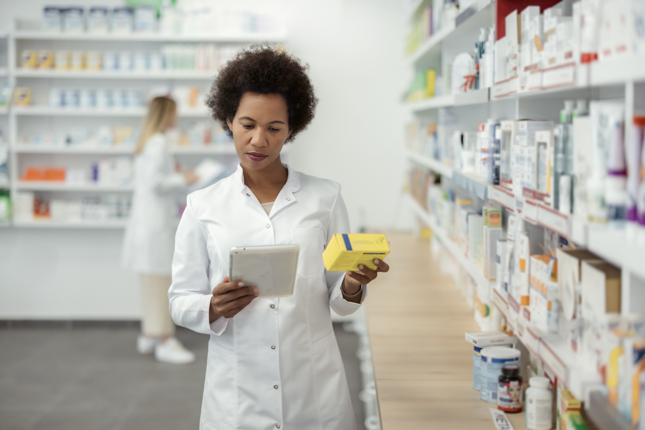 A pharmacist looking at an iPad