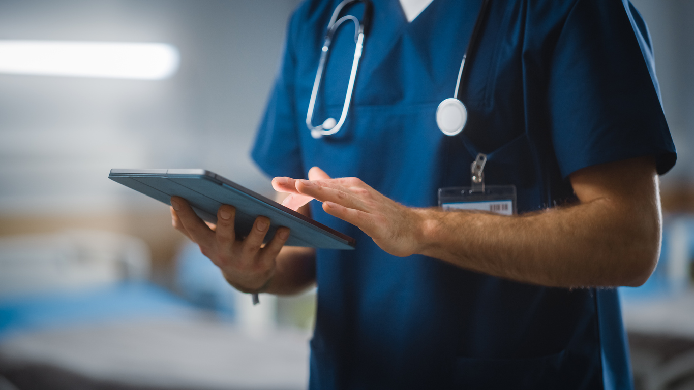 A clinician looking at an iPad