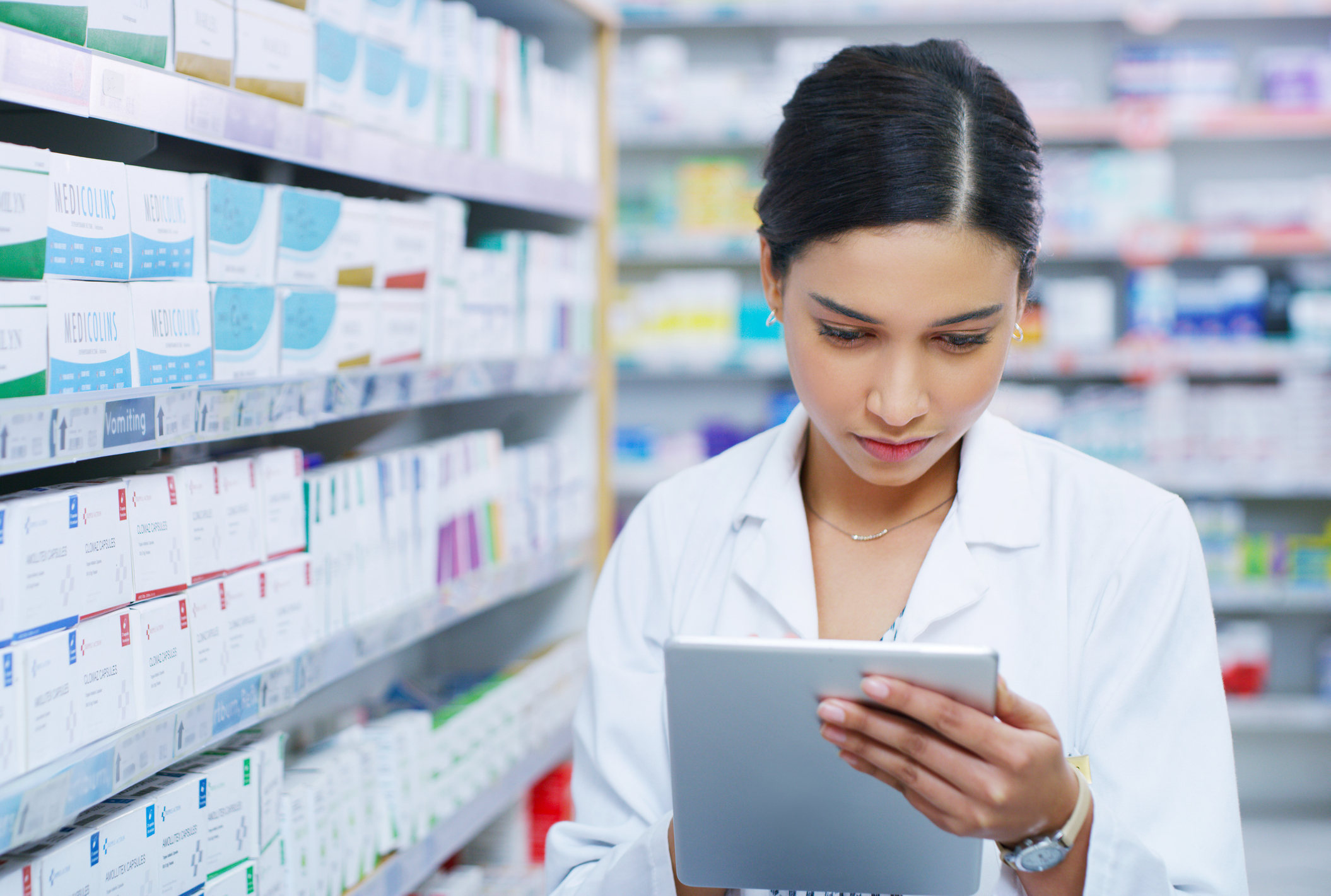 A pharmacist holding an iPad