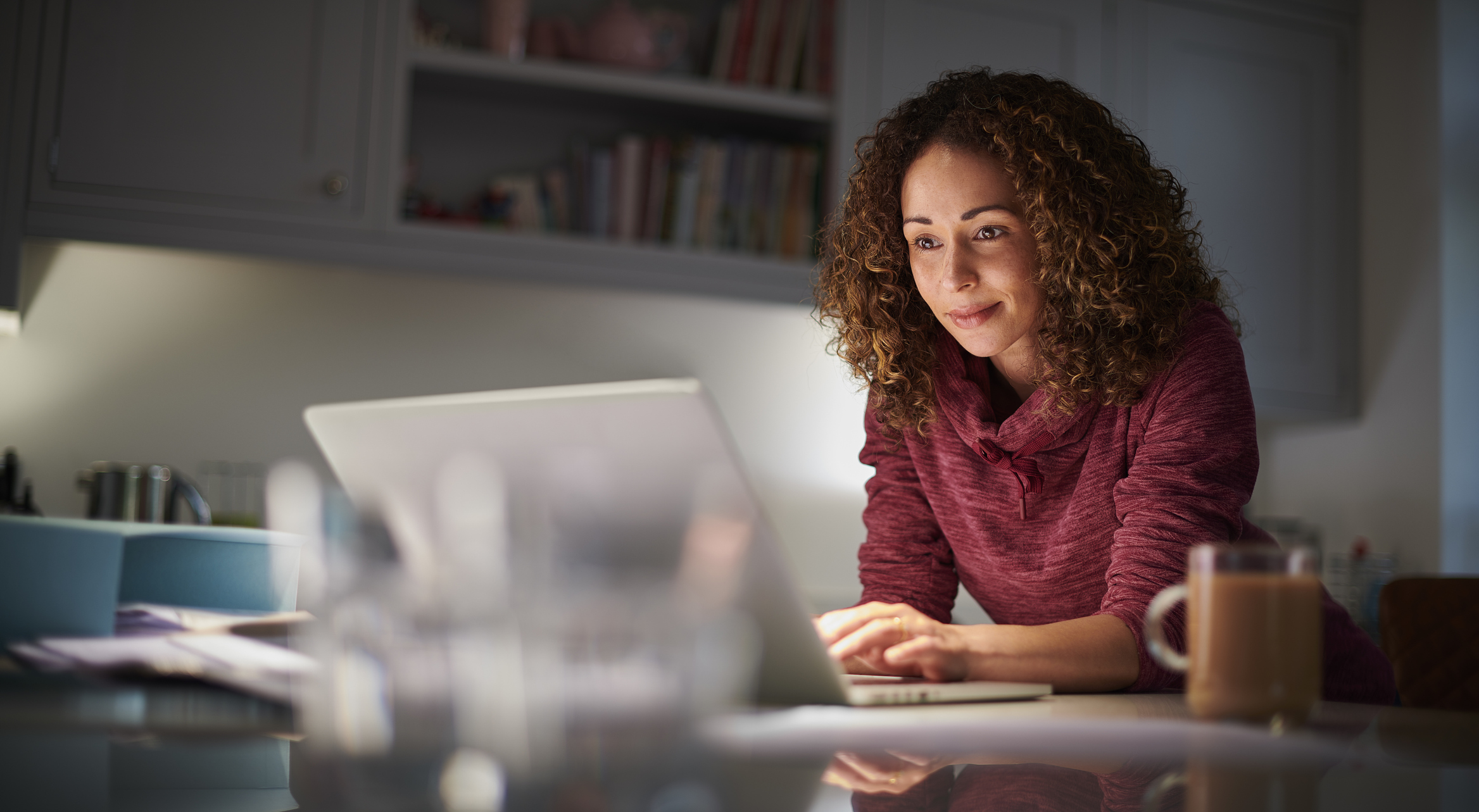 A woman looking at a laptop