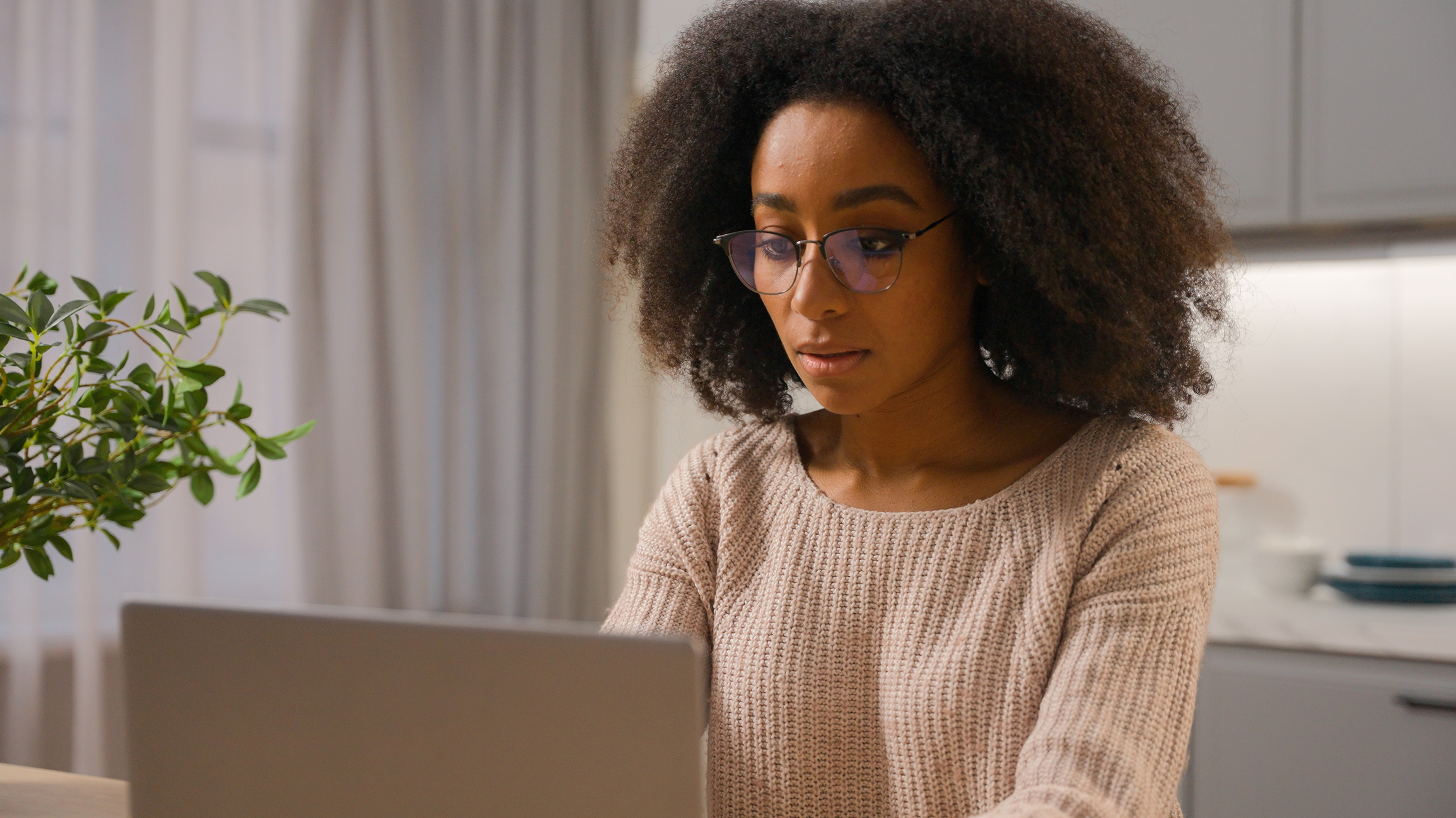 A woman looking at a laptop