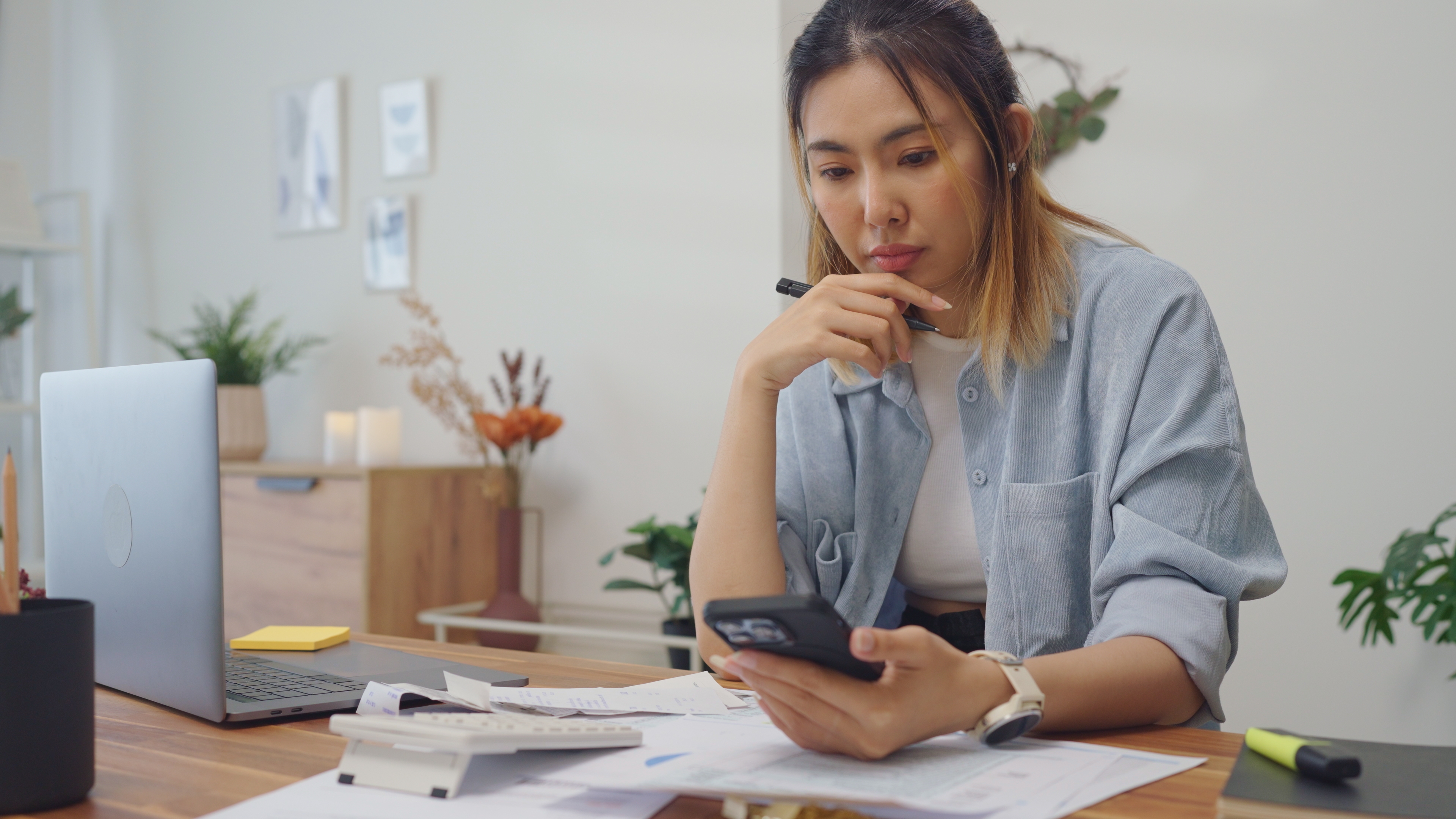 A woman looking at an iPhone