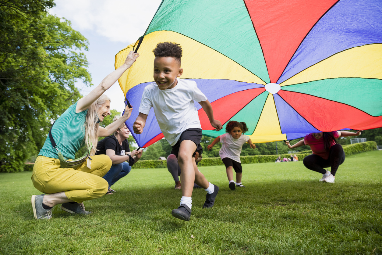 A child smiling and running in a field