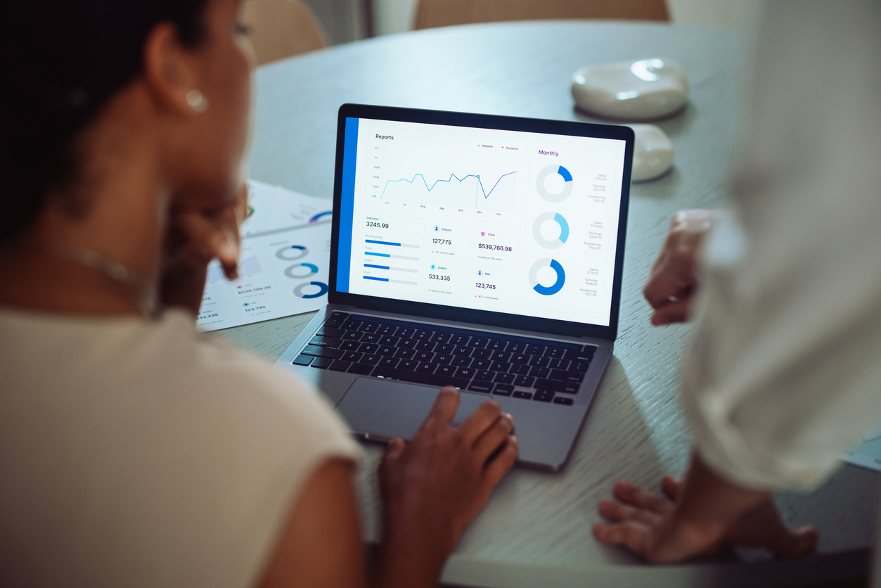 A woman looking at statistics on a laptop
