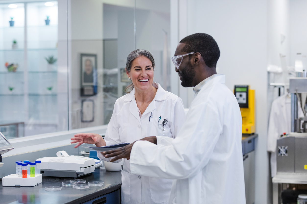 Two people talking in a lab