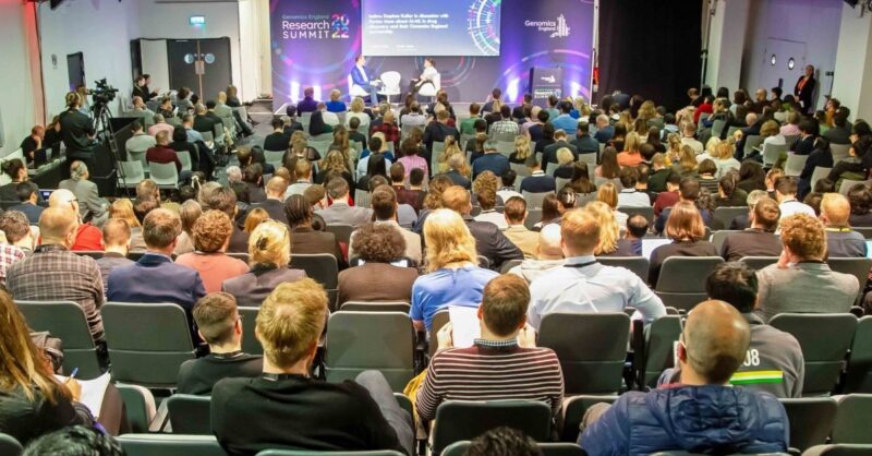 A conference room full of people watching a presentation