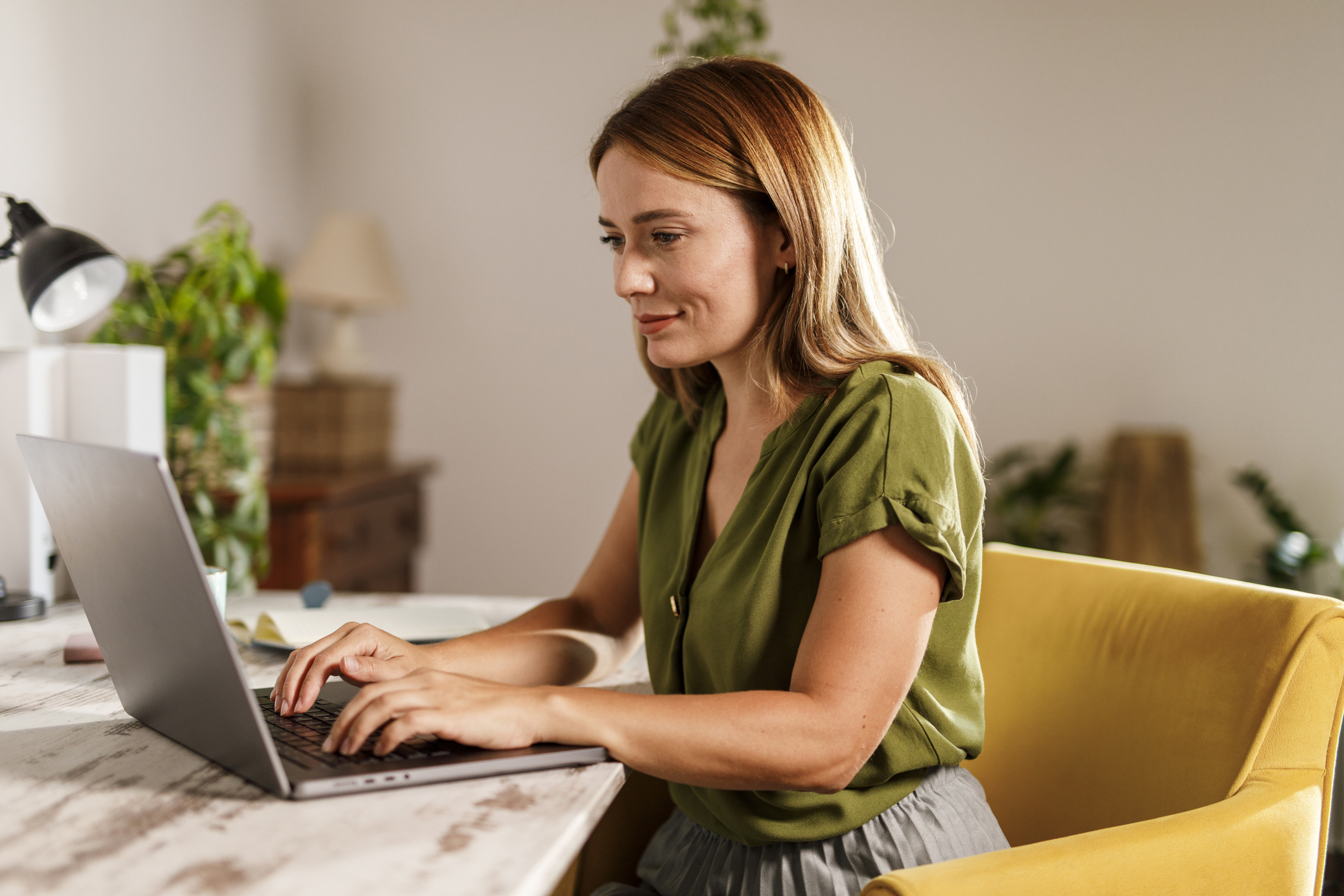 A woman looking at a laptop