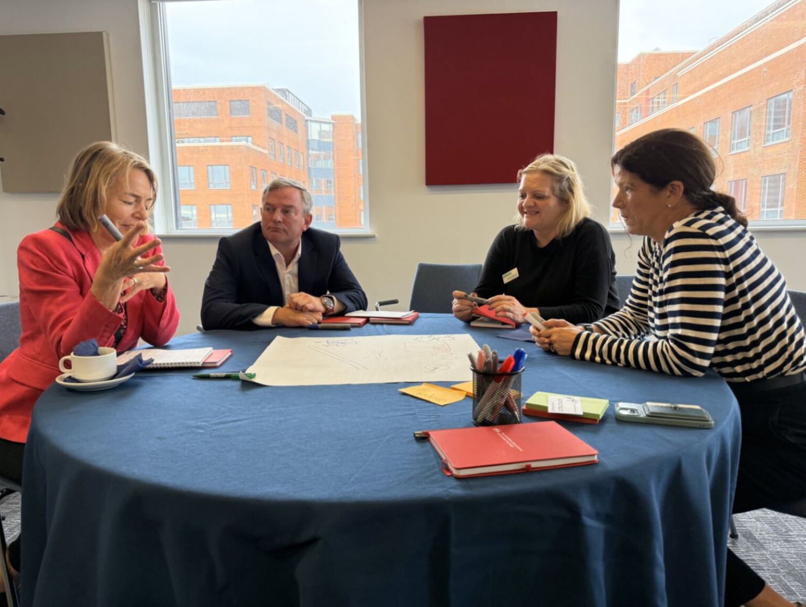 Group of people sitting around a table.