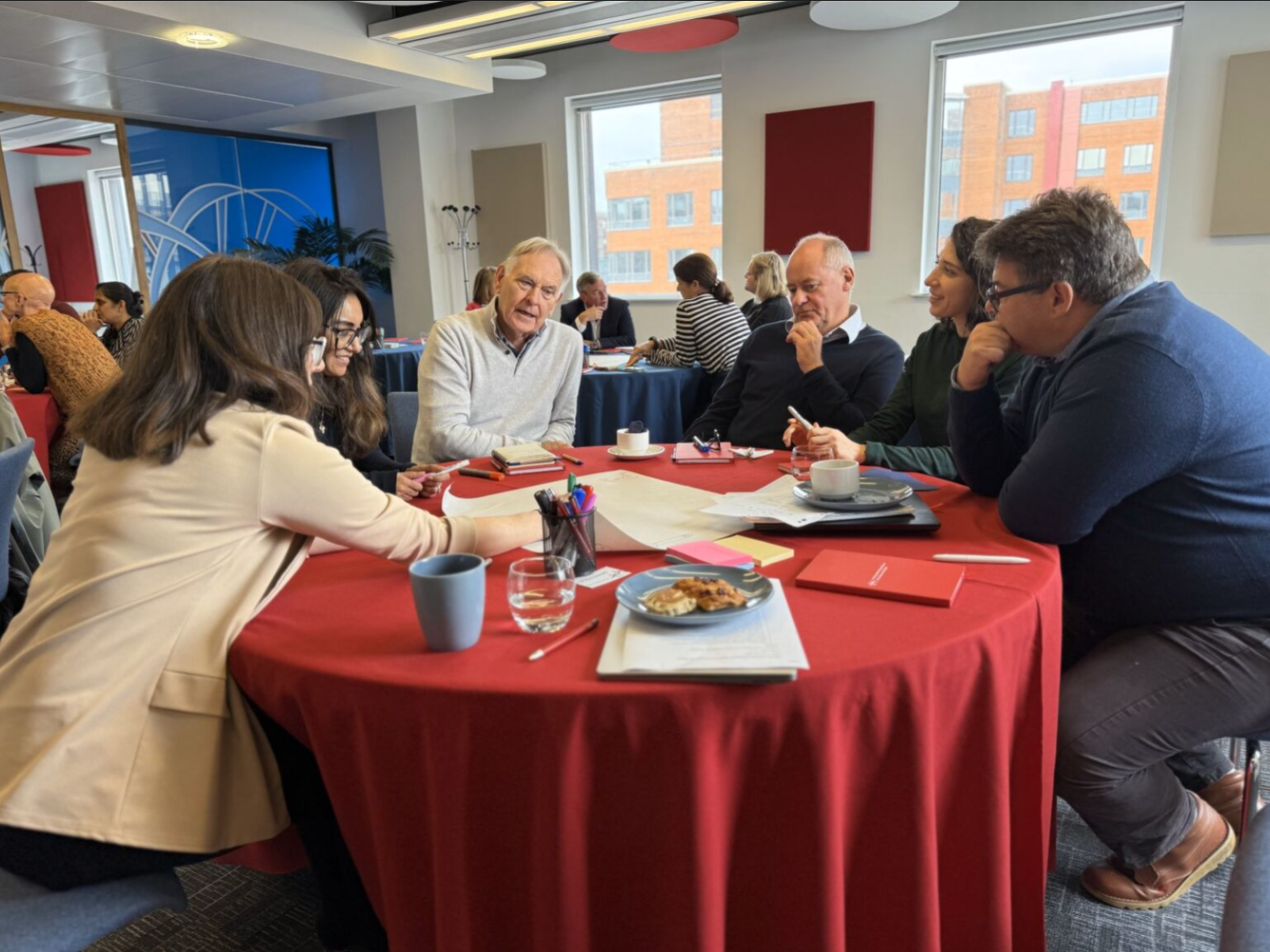 Group of people sitting around a table.