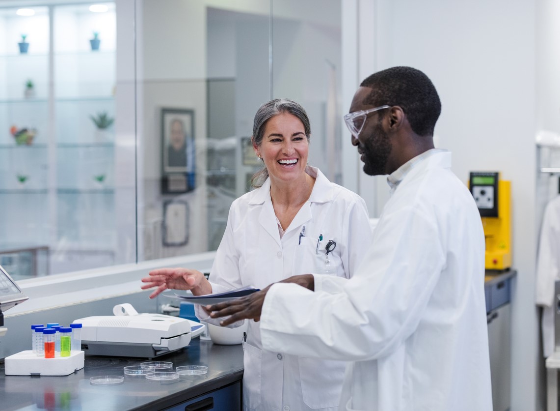 Two people talking in a lab.