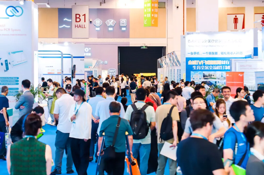 A crowd of people at the Medical Fair China. Everyone is busy looking at stands and walking.